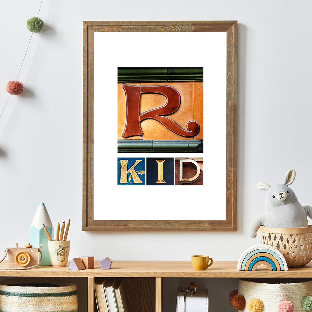 wooden framed image with large R and kid underneath in colourful letters